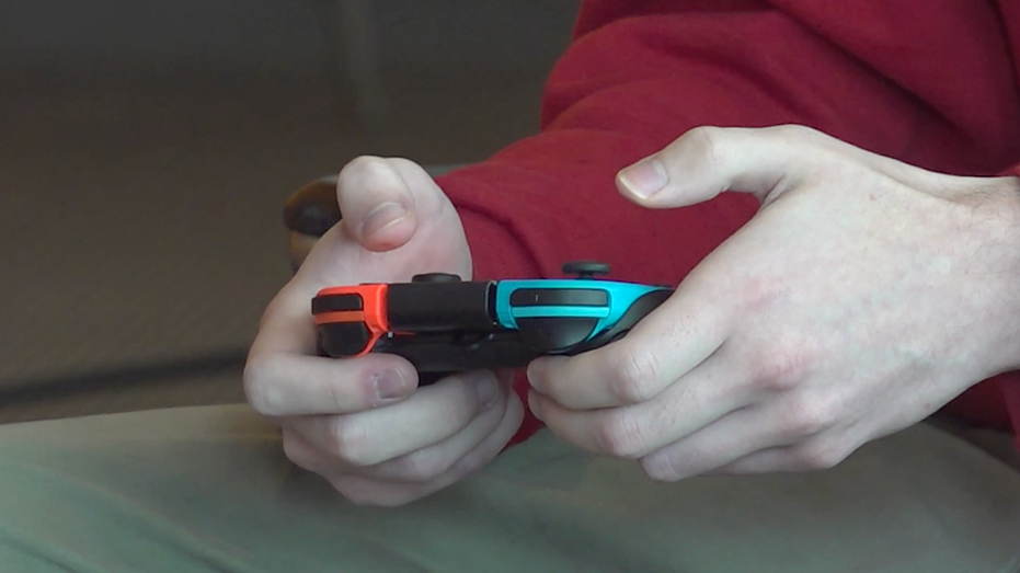 Esports player holding game controller