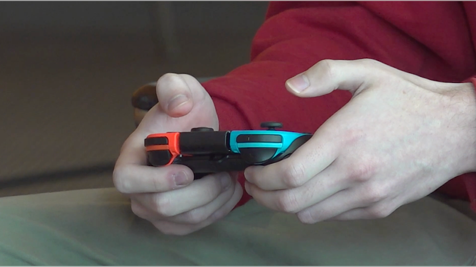 Esports player holding game controller