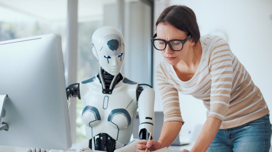 robot and female office worker working together