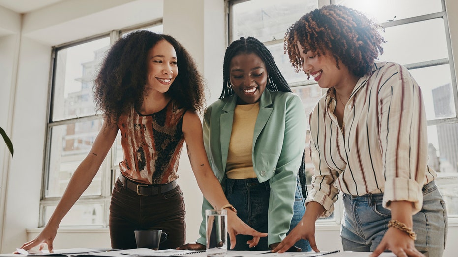 Women collaborate in an office