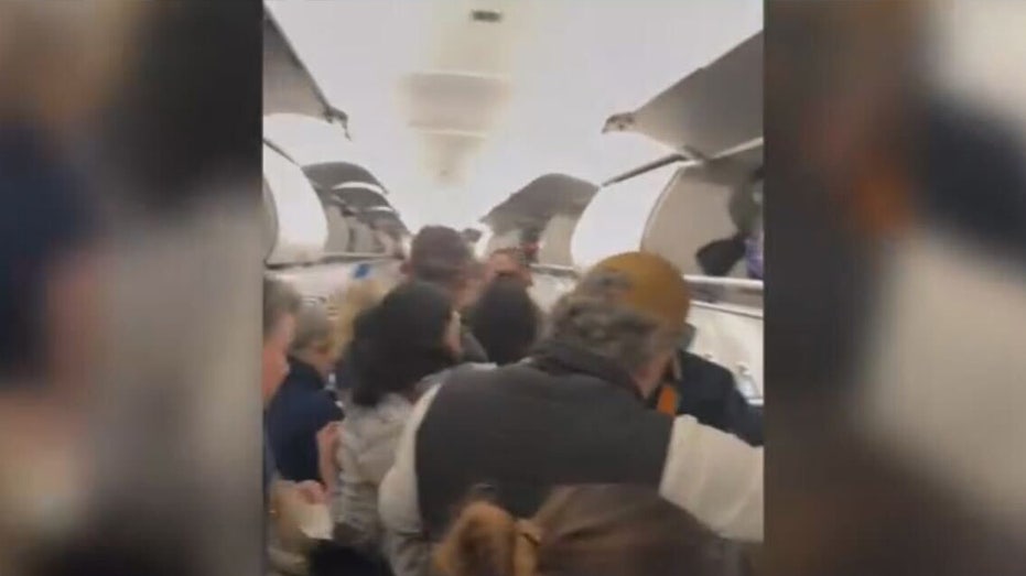 Passengers evacuate from the plane