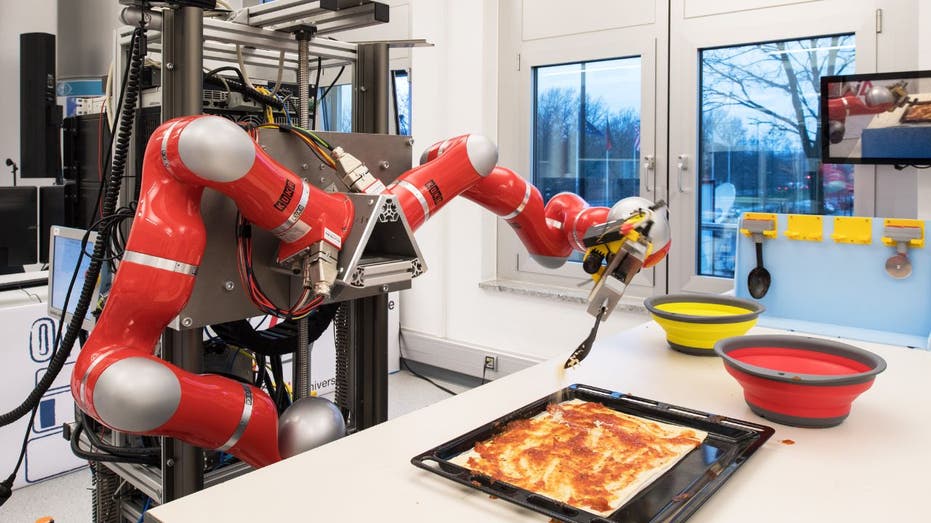 a robot making a pizza