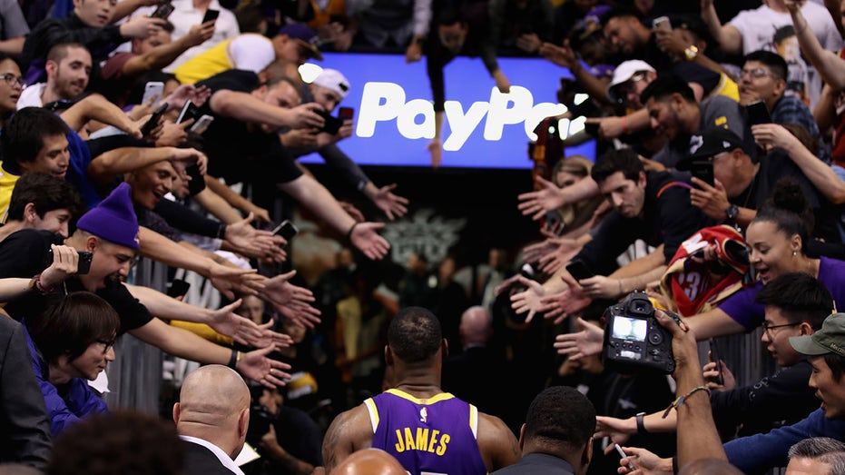 LeBron James walks past fans