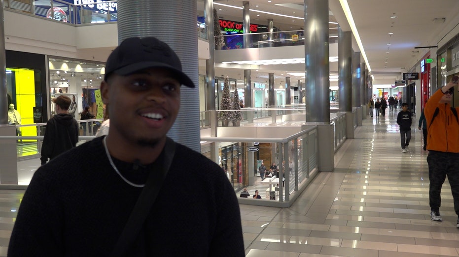 a young man looks at reporter while standing in mall of america