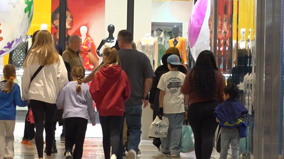 Crowd of people walking through mall