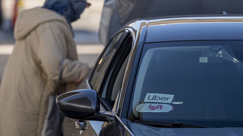 Uber and Lyft signage spotted on a vehicle at Oakland International Airport