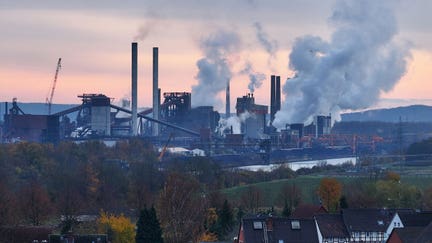 SALZGITTER, GERMANY - NOVEMBER 22: In this aerial view water vapour and exhaust rise from the steel mill of Salzgitter AG, one of Europe's largest steel producers, as residential buildings stand nearby on November 22, 2023 in Salzgitter, Germany. Demands are rising that countries participating in the upcoming UNFCCC COP28 climate conference in Dubai agree on a roadmap for phasing out the use of fossil fuels. Meanwhile the United States and China have agreed to triple global renewable energy production by 2030, raising hope that real progress on mitigating climate change will be possible at COP28. The Salzgitter mill was Germany's fourth biggest emitter of CO2 in 2022. The company is investing heavily towards CO2-free steel production. (Photo by Sean Gallup/Getty Images)
