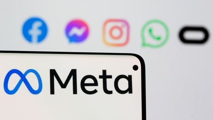 Facebook's new rebrand logo Meta is seen on smartpone in front of displayed logo of Facebook, Messenger, Intagram, Whatsapp and Oculus in this illustration picture taken October 28, 2021. REUTERS/Dado Ruvic/Illustration
