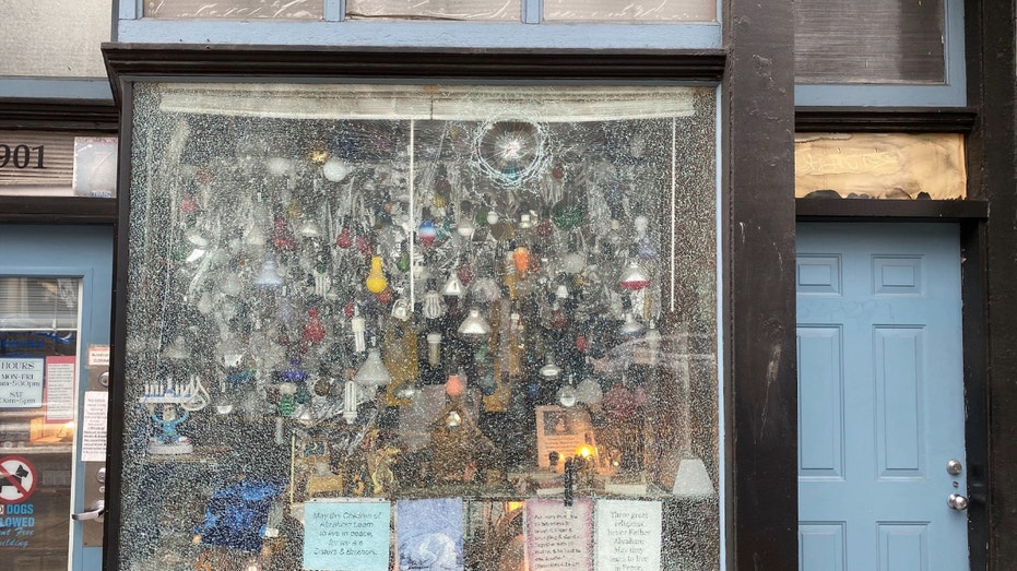 Kay Newell's storefront window being damaged