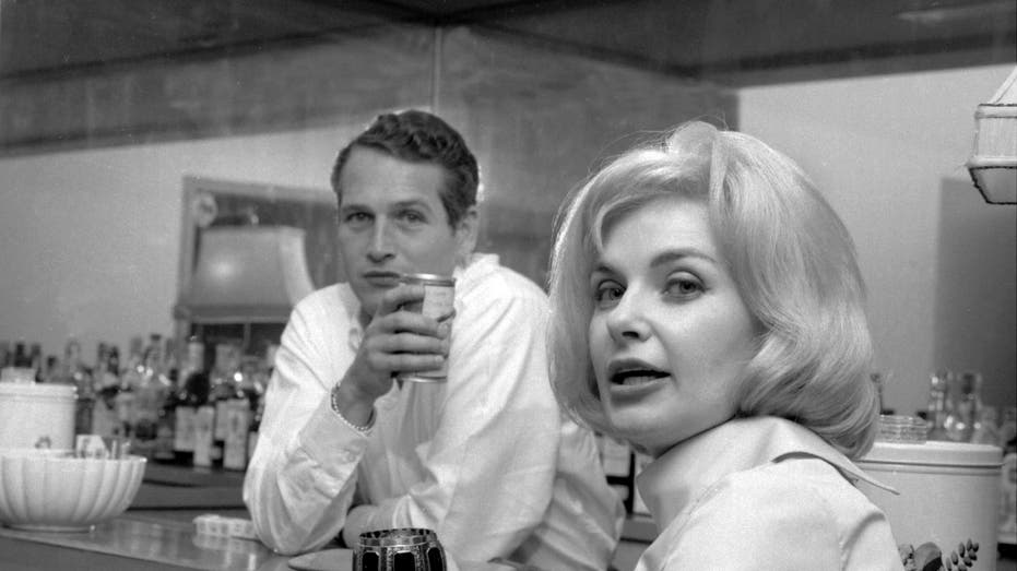 Paul Newman and Joanne Woodward pose in their home