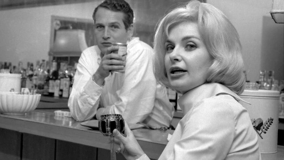 Paul Newman and Joanne Woodward pose in their home