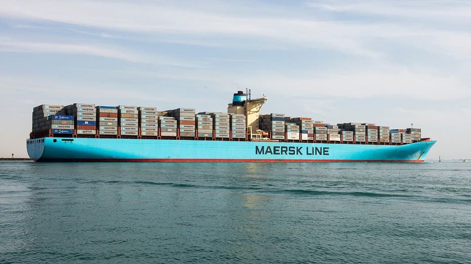 A light blue colored Maersk container ship heading towards the Red Sea after passing through the Suez Canal in Suez, Egypt.