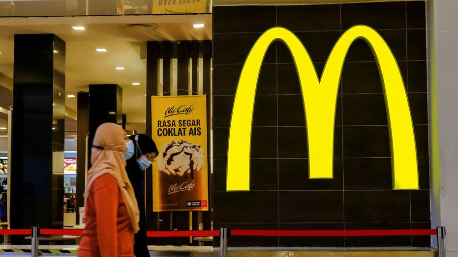 Woman walking past McDonald's