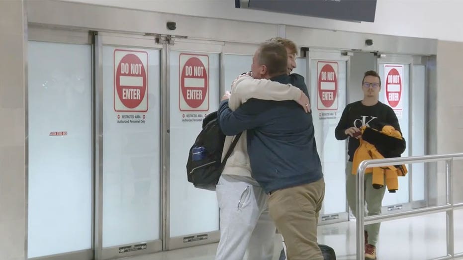 Michigan man hugs dad following flight diversion