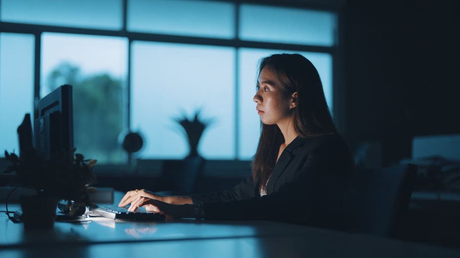 businesswoman in office late at night