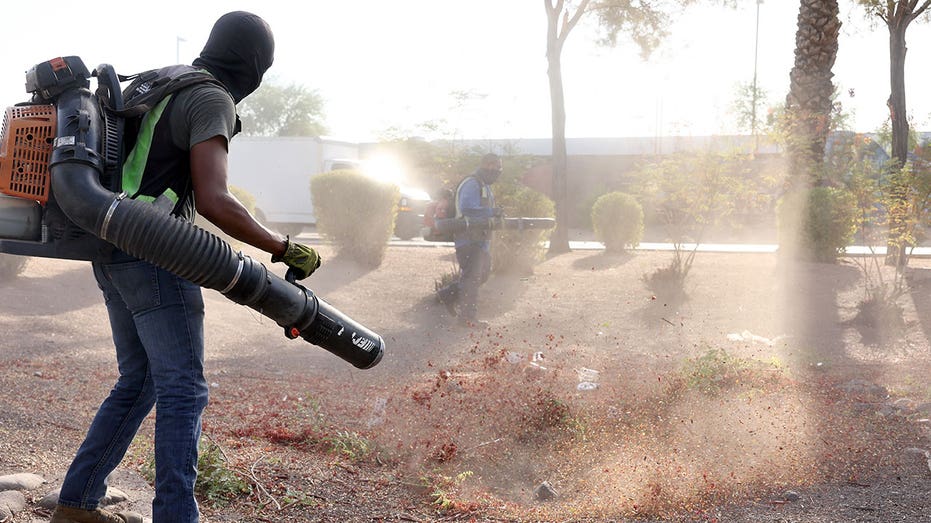 A man uses a leaf blower