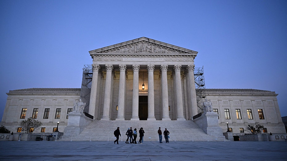 People walk past the US Supreme Court in Washington, DC