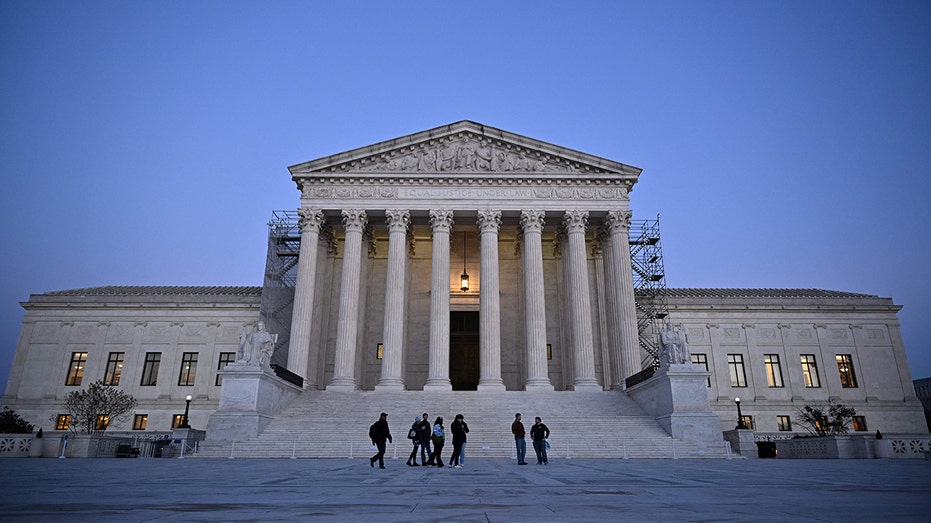 People walk past the US Supreme Court in Washington, DC