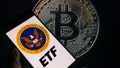 The seal of the U.S. Securities and Exchange Commission is being displayed on a smartphone, with Bitcoin visible on the screen in the background, in this photo illustration taken in Brussels, Belgium, on January 9, 2024. 