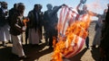 SANA'A, YEMEN - JANUARY 14: Houthi followers burn the Israeli and American flags during a tribal gathering on January 14, 2024 on the outskirts of Sana'a, Yemen. Houthi followers gathered to protest against the U.S.-U.K. airstrikes on positions in areas under their control. (Photo by Mohammed Hamoud/Getty Images)
