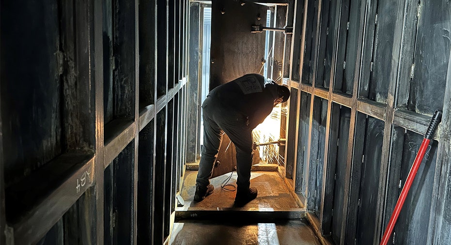 Worker performs welding work on bunker