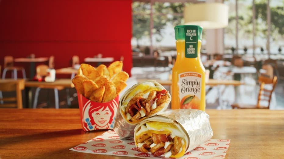 Wendy's Breakfast Burrito with orange juice bottle