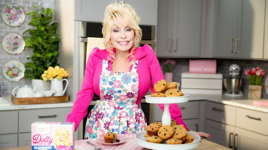 Dolly Parton standing near tray of cookies