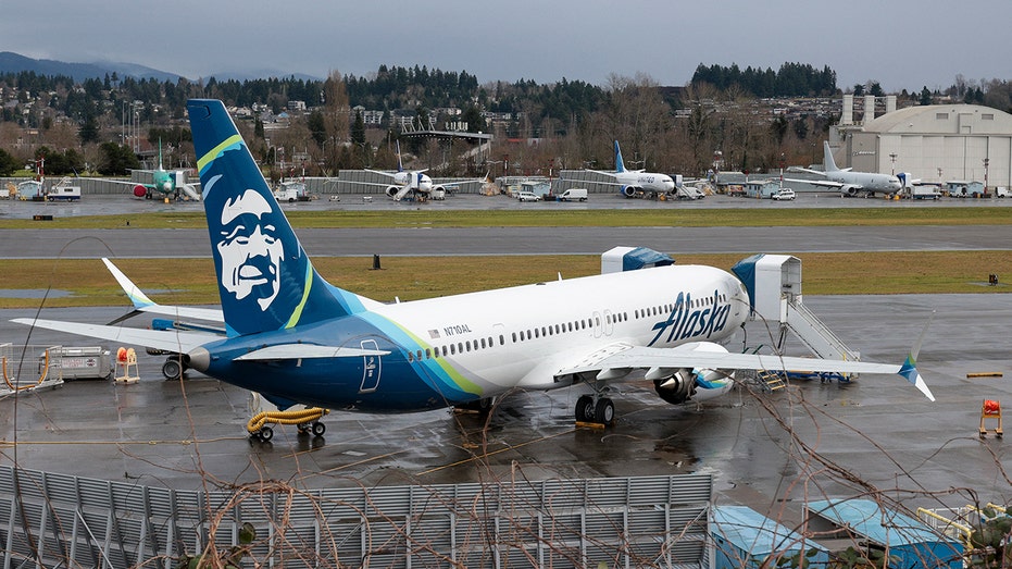 A Boeing 737 Max 9 for Alaska Airlines is parked at the airport