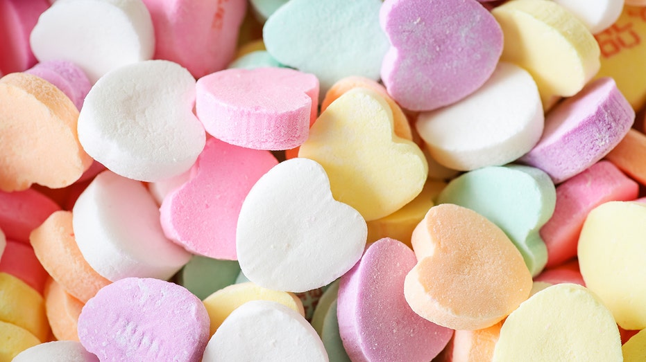 Colorful pile of pastel candy hearts.