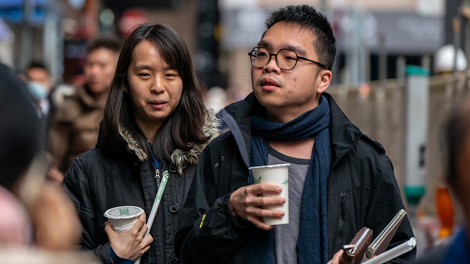 A couple is holding drinks