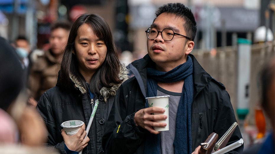 A couple is holding drinks 