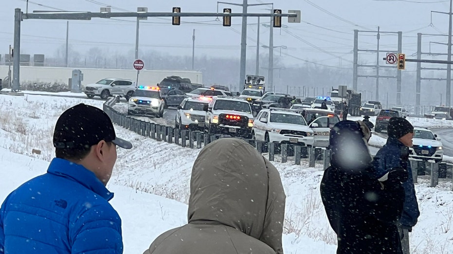 Bystanders observe closed lanes on the Loudoun County Parkway