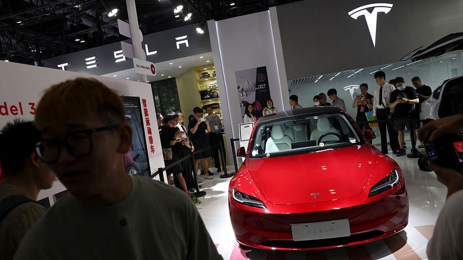 A red Tesla Model 3 on display in China