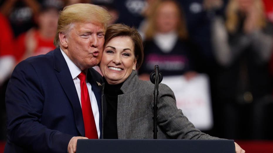 Gov. Kim Reynolds on stage with Trump