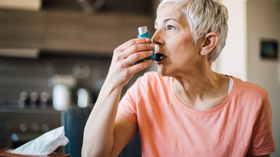 Woman using inhaler