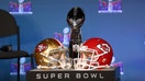 LAS VEGAS, NV - FEBRUARY 05: The Lombardi Trophy sits on stage with the helmets of the San Francisco 49ers and the Kansas City Chiefs during the Super Bowl LVIII Commissioner&apos;s Press Conference on February 05, 2024, at Allegiant Stadium in Las Vegas, NV.