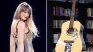 Taylor Swift's signed Eras Tour guitar raffled for big bucks at school for foster kids