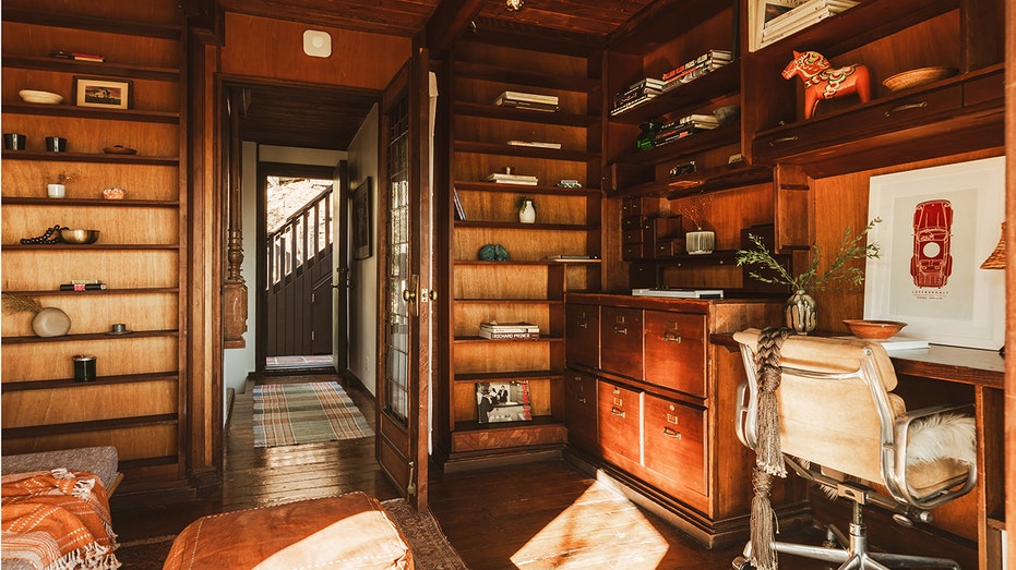 An office featuring shelves and a chair.