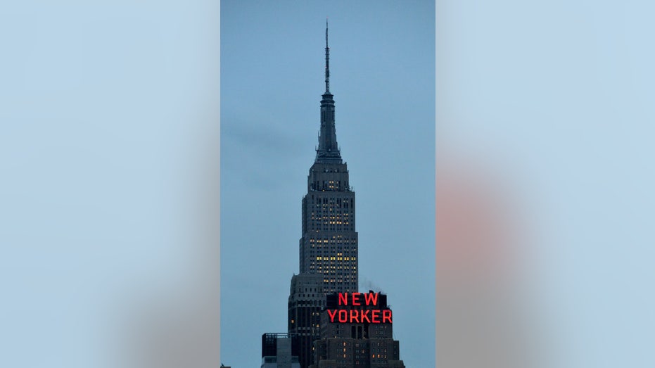 New Yorker hotel pictured in front of Empire State Building