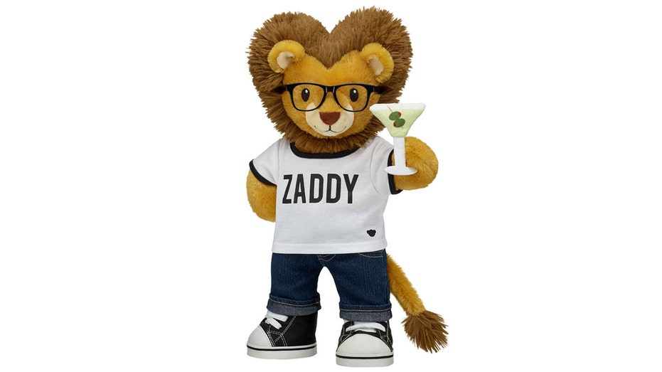A stuffed lion with a "Zaddy" shirt