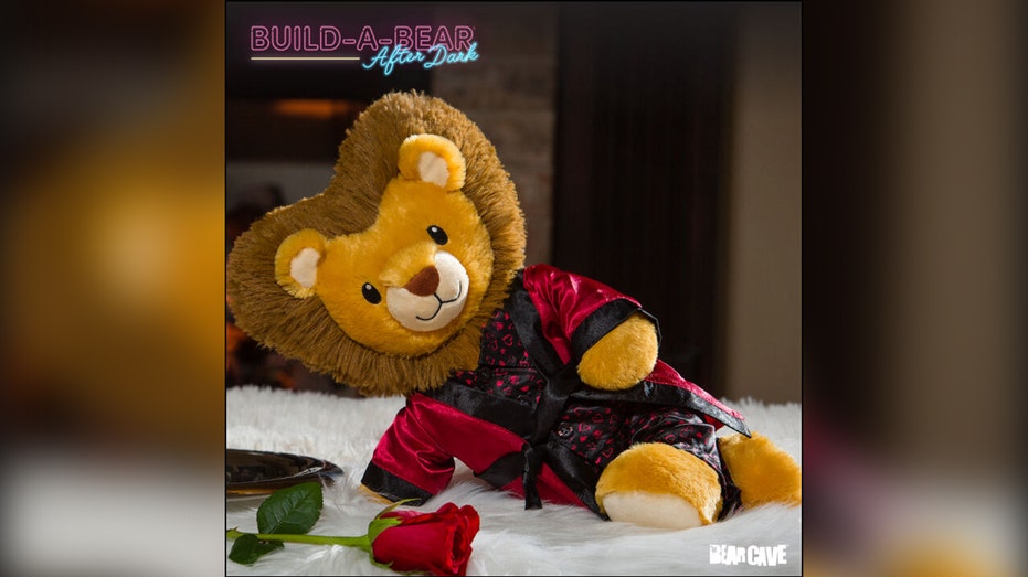 A stuffed lion in a satin robe posed suggestively