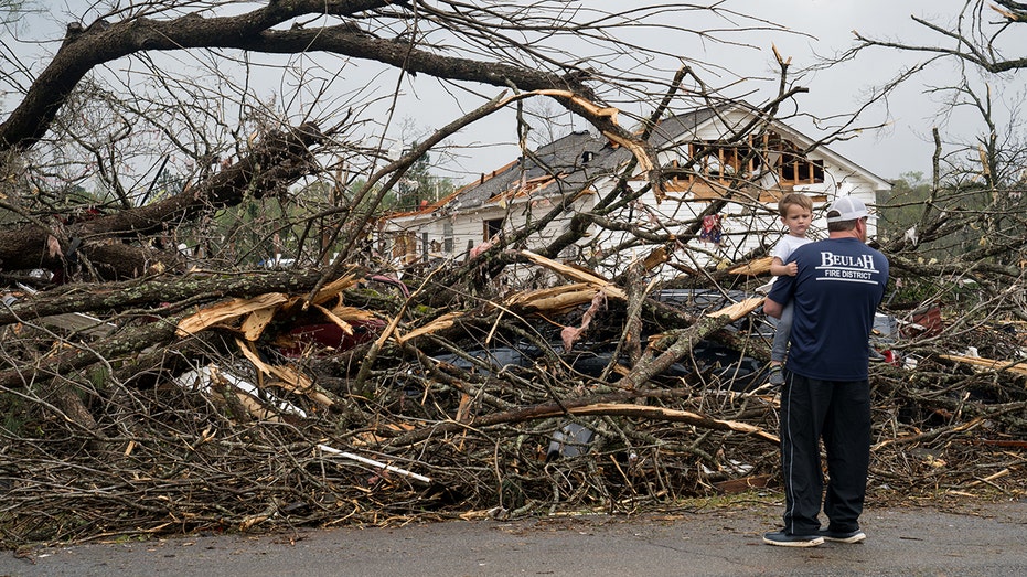 A family surveys damage from a Tornado in Georgia