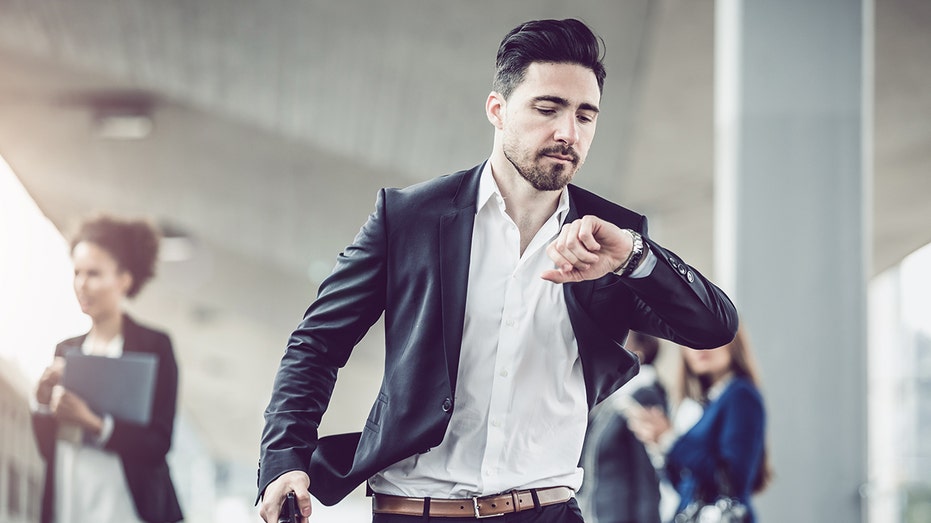 Businessman Checking the Time