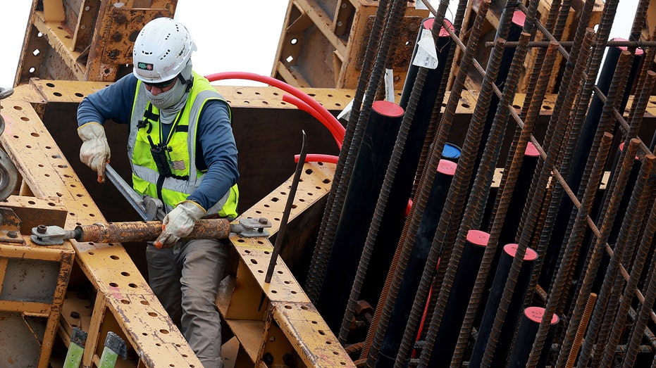 A construction worker helps build a bridge in Miami