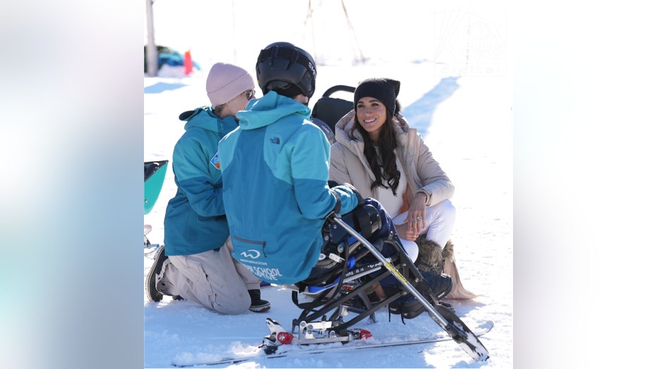 Meghan Markle talking to other skiiers