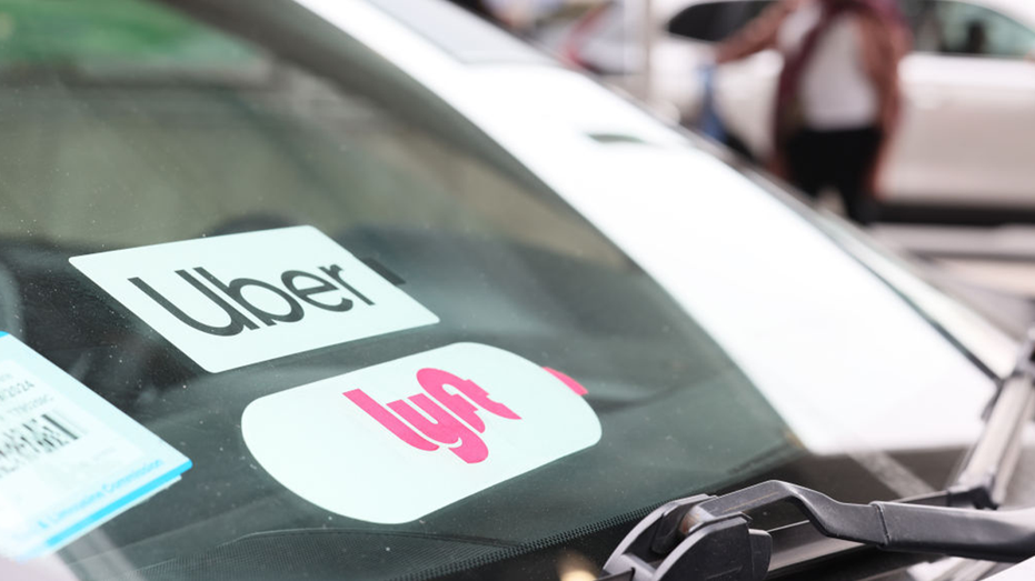 Uber and Lyft decals on a car