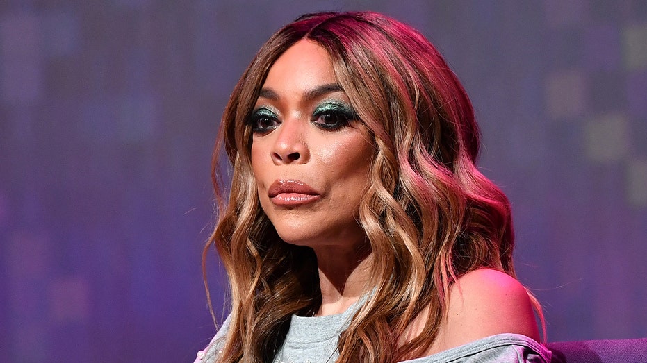 Wendy Williams wears off the shoulder grey blouse.