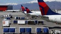 Delta Airlines planes are loaded and unloaded at Salt Lake City International Airport in April 2020.