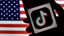 In this photo illustration, the social media application logo, TikTok is displayed on the screen of an iPhone on an American flag background on August 3, 2020 in Arlington, Virginia. - The US Senate voted on August 6, 2020, to bar TikTok from being downloaded onto US government employees&apos; telephones, intensifying US scrutiny of the popular Chinese-owned video app. The bill passed by the Republican controlled Senate now goes to the House of Representatives, led by Democrats. (Photo by Olivier DOULIERY / AFP) (Photo by OLIVIER DOULIERY/AFP via Getty Images)