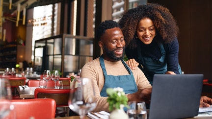 Small business owners looking at their laptop.